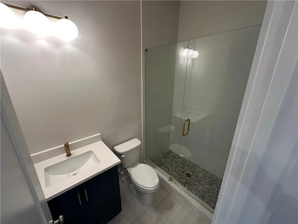 Full bath with vanity and a shower stall