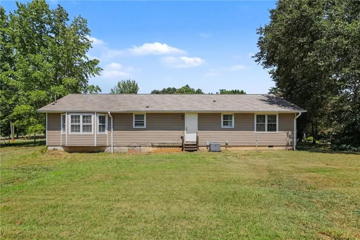 Expansive grassy yard with mature trees