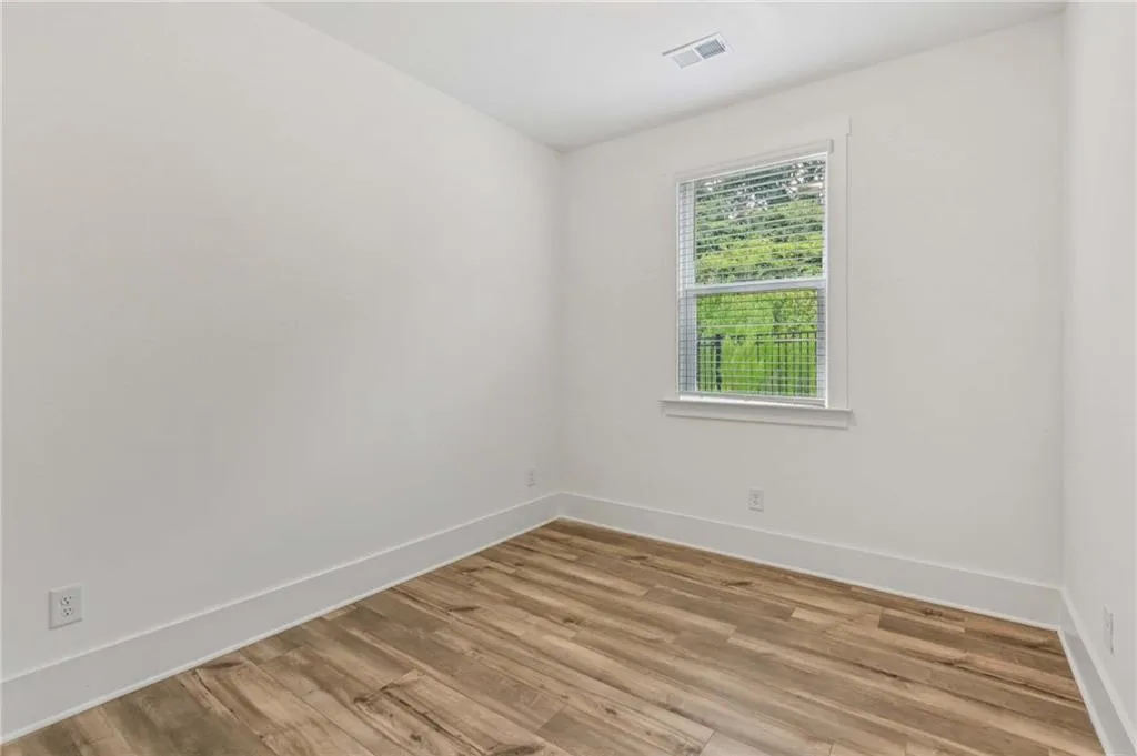 Unfurnished room featuring baseboards and light wood finished floors