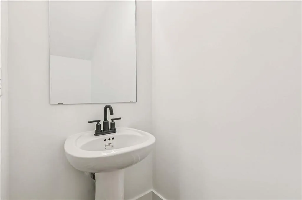 Bathroom featuring a sink and baseboards