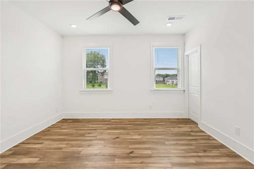Unfurnished room with a ceiling fan, light wood-type flooring, and recessed lighting