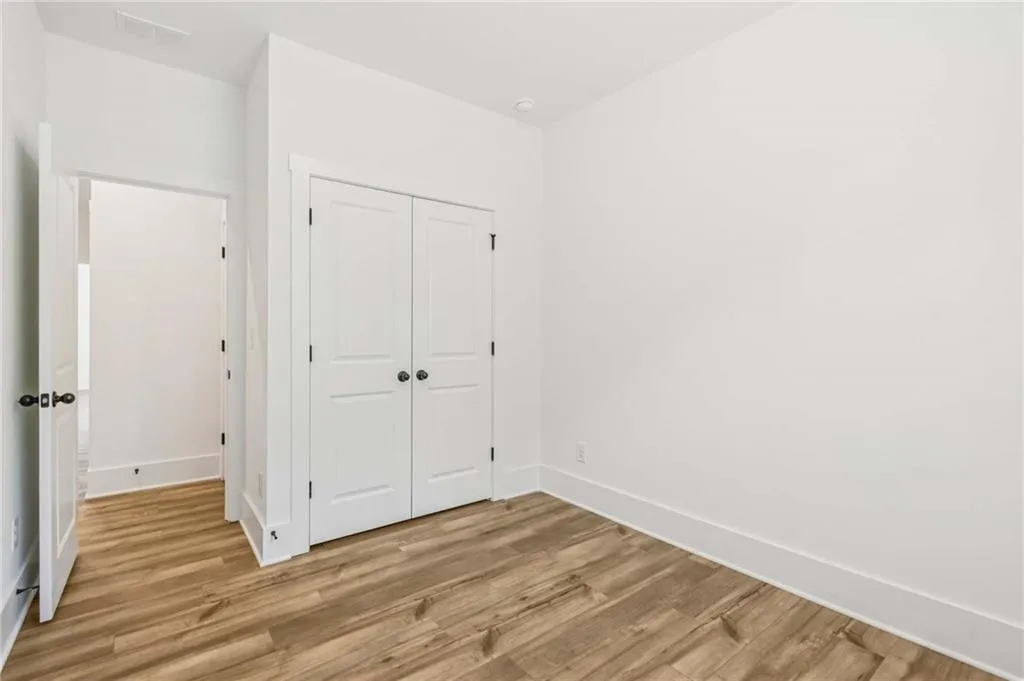 Unfurnished bedroom featuring light wood-style flooring and a closet