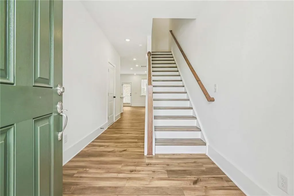 Foyer with stairway, light wood-style floors, and recessed lighting