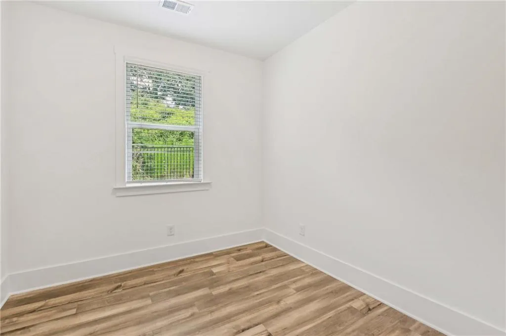 Spare room with light wood-type flooring and baseboards