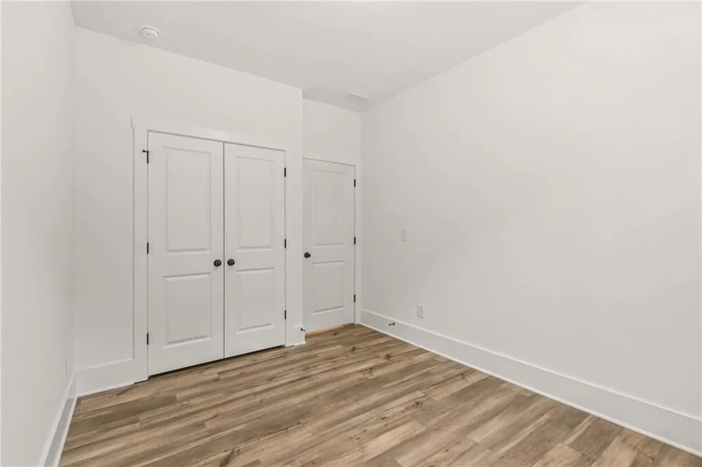 Unfurnished bedroom featuring light wood-style flooring and a closet