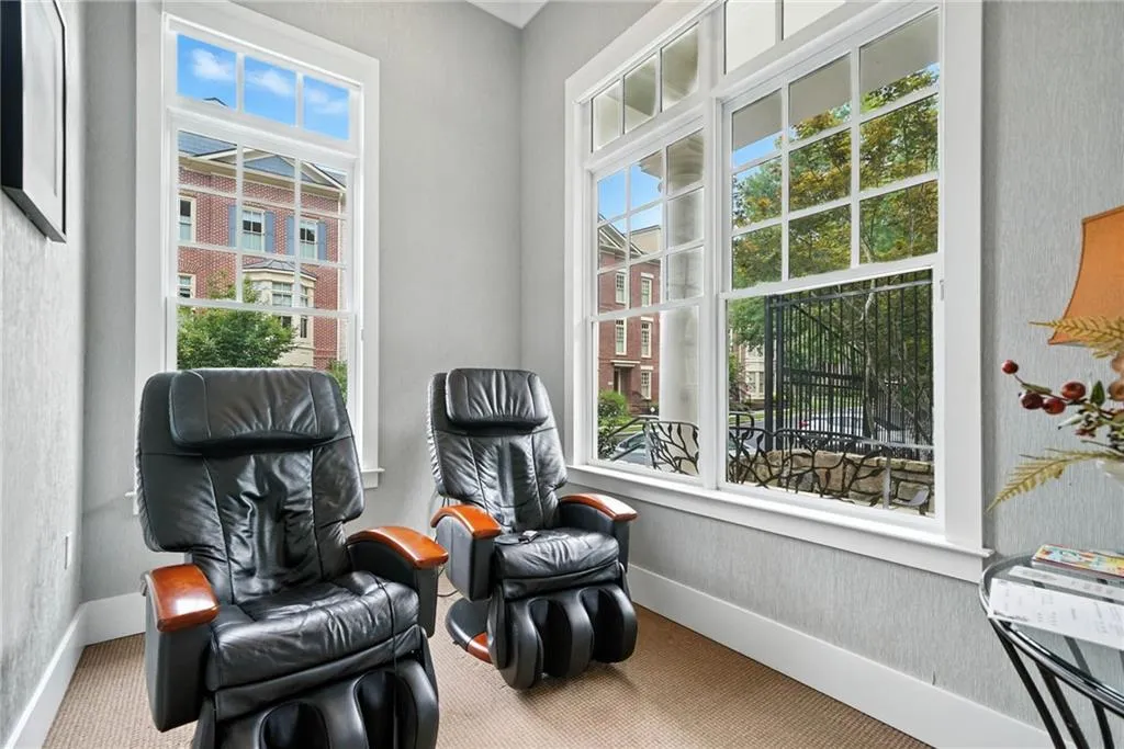 Living area featuring carpet floors and baseboards