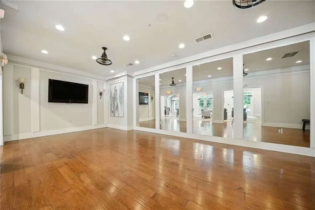Workout room with hardwood / wood-style floors, recessed lighting, ornamental molding, and ceiling fan