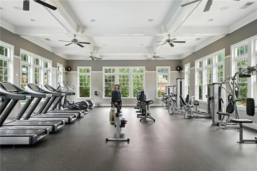 Exercise room featuring beamed ceiling, recessed lighting, coffered ceiling, and ceiling fan