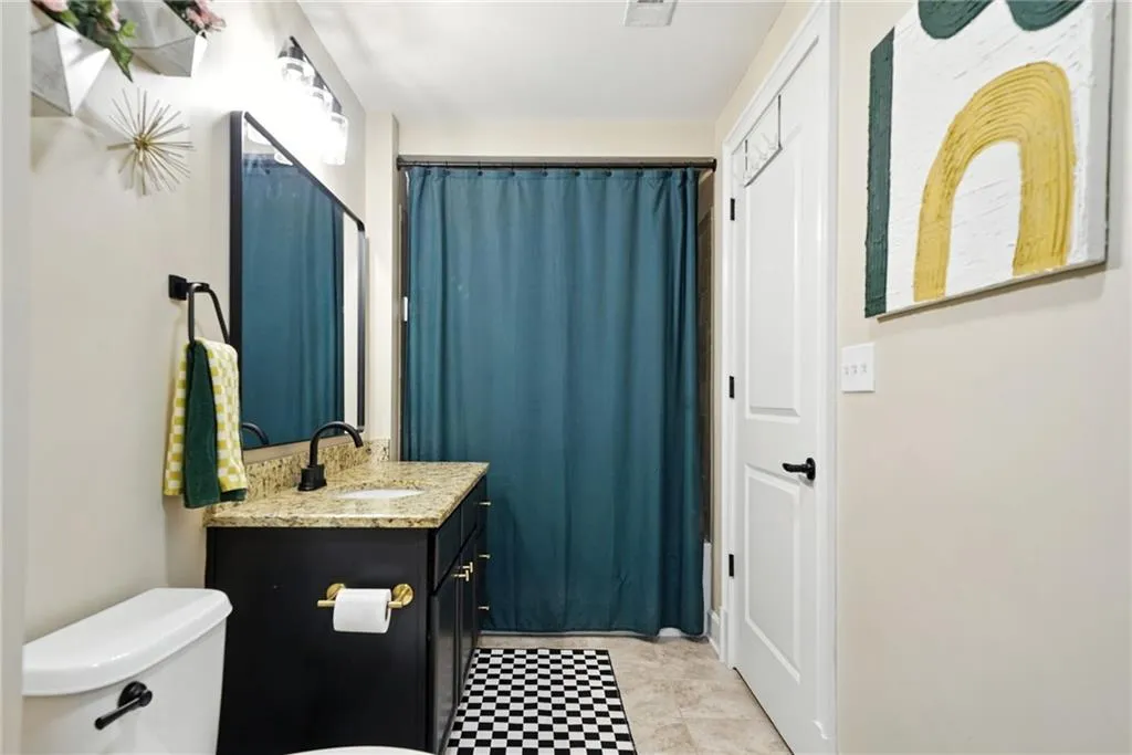 Full bathroom featuring vanity and toilet