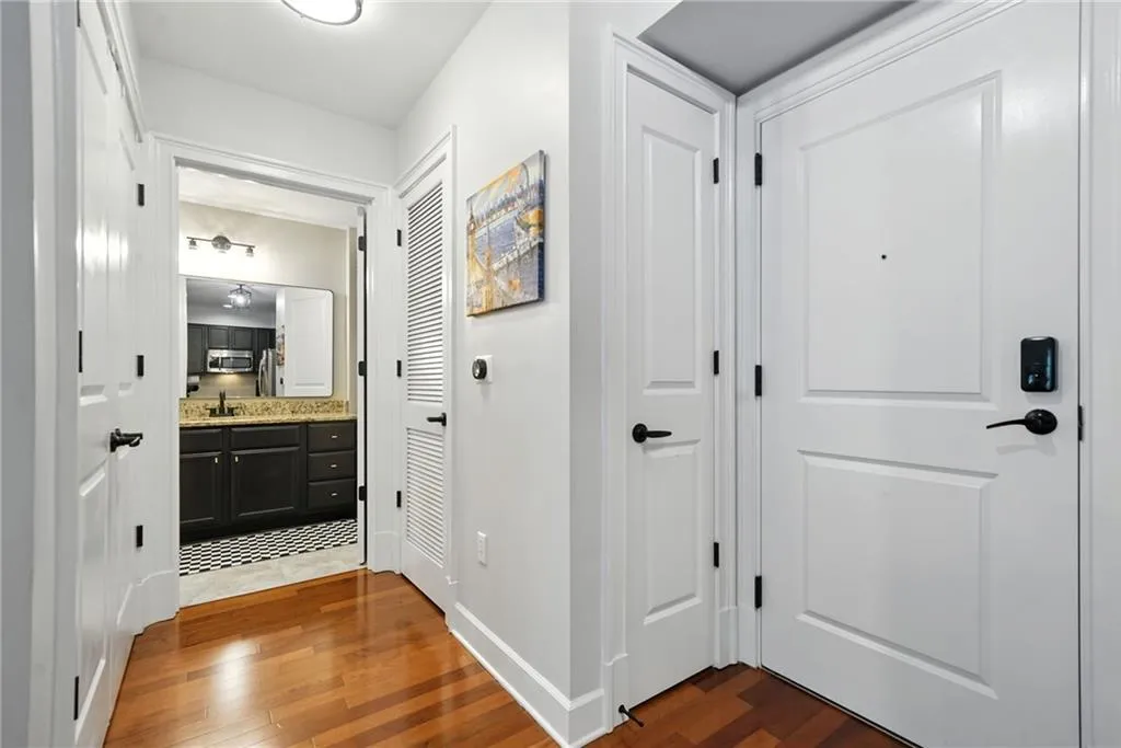 Hallway featuring dark wood-type flooring and baseboards