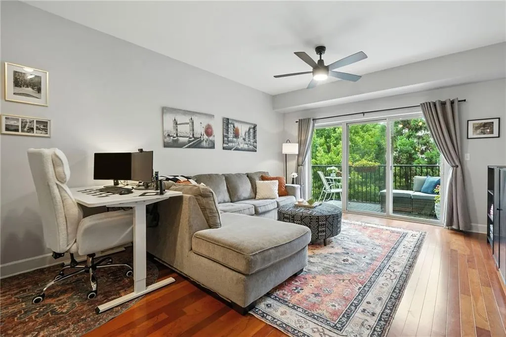 Living area with wood-type flooring, an office area, and ceiling fan