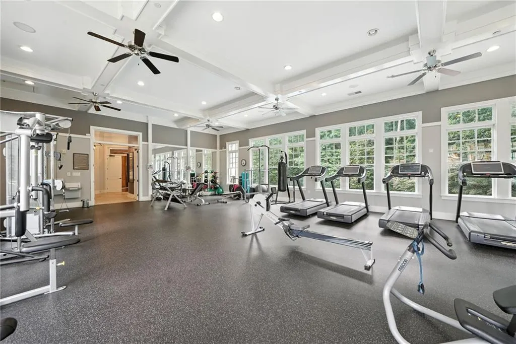 Workout area with beam ceiling, coffered ceiling, and recessed lighting