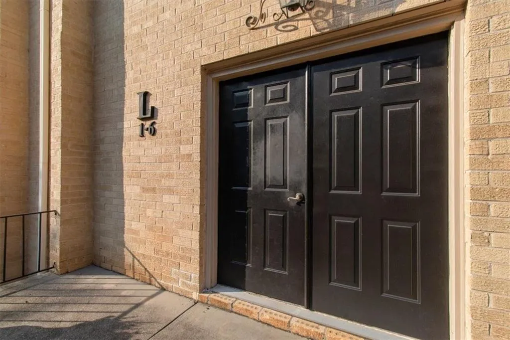 View of exterior entry featuring brick siding