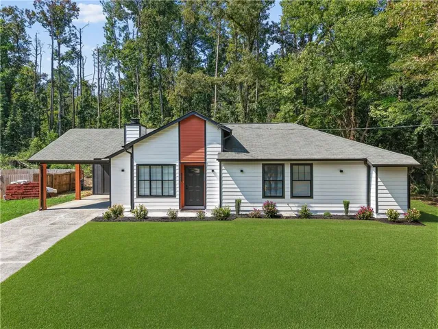 White horizontal siding exterior with a dark trim roofline, accented by a red vertical siding facade