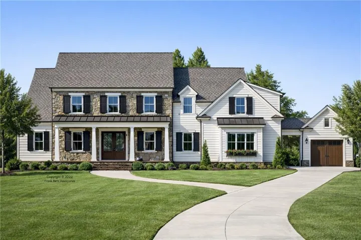 Stone and siding exterior with dark shutters, featuring a covered front porch with columns