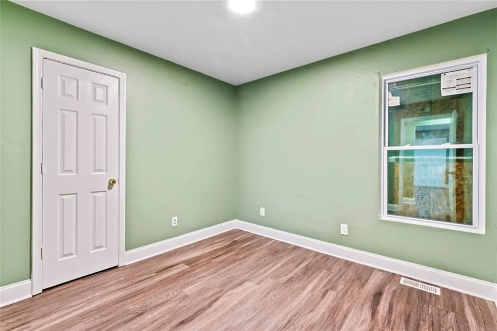 Empty room featuring wood finished floors and baseboards