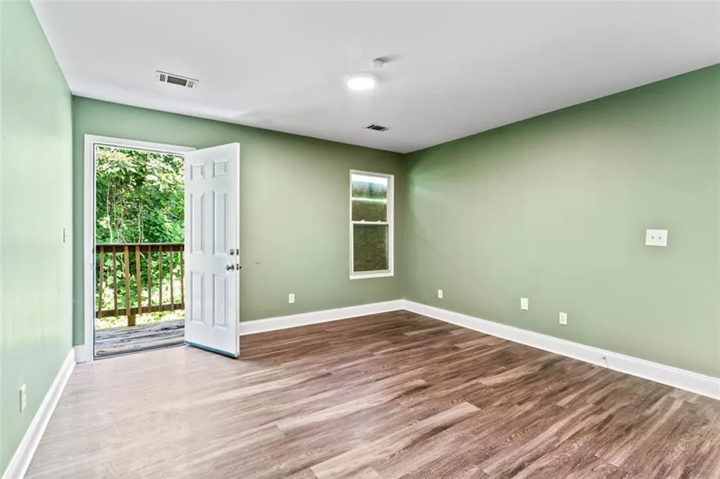 Empty room with wood finished floors and plenty of natural light