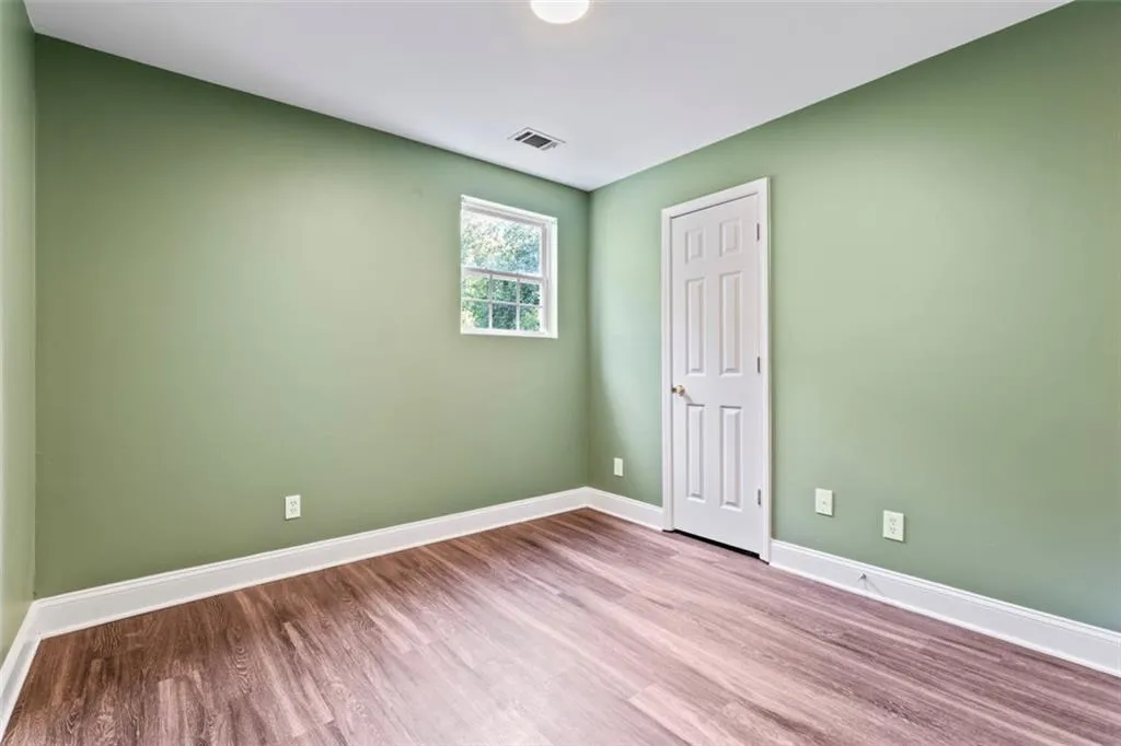 Unfurnished room featuring wood finished floors and baseboards