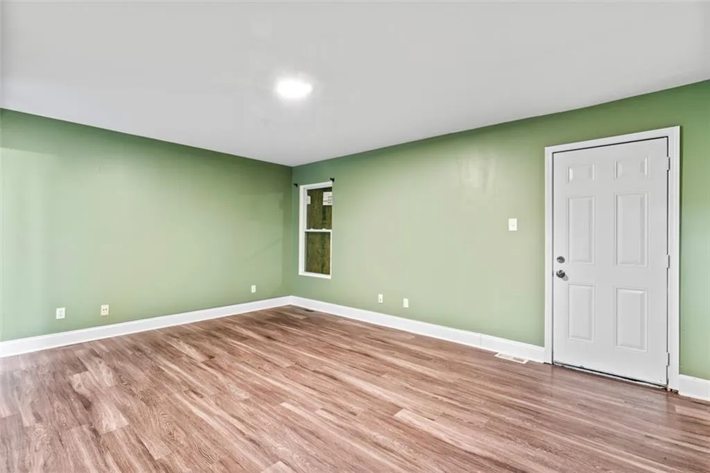 Spare room with wood finished floors