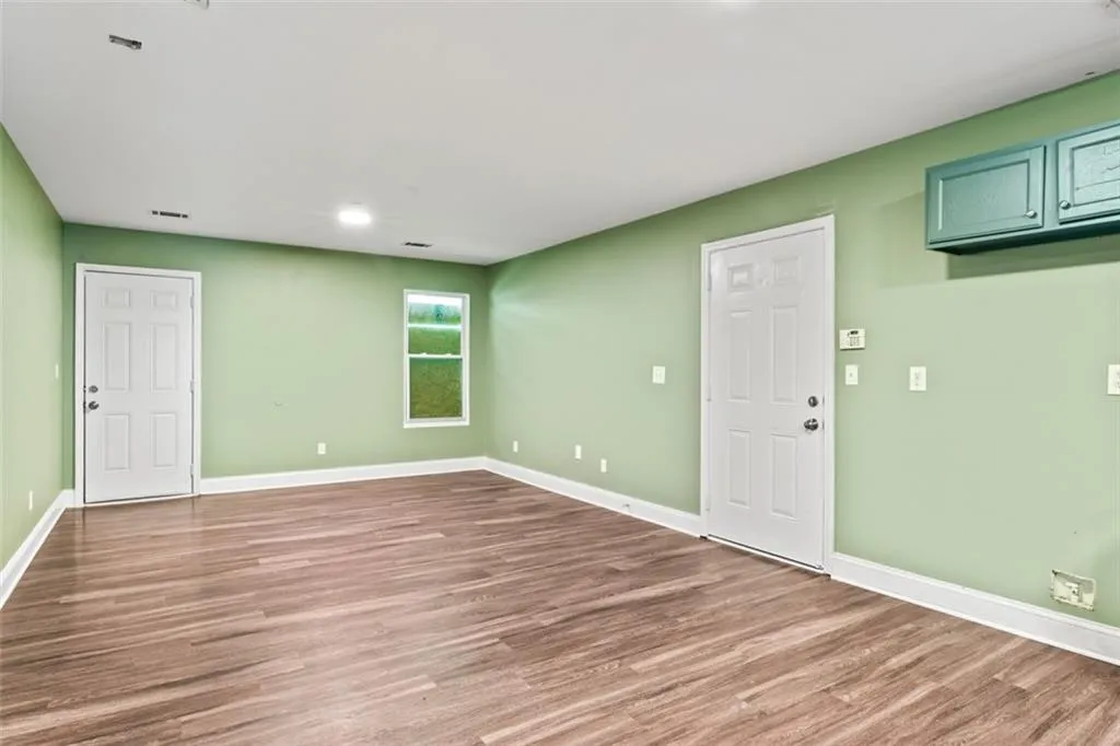 Unfurnished room featuring wood finished floors and baseboards