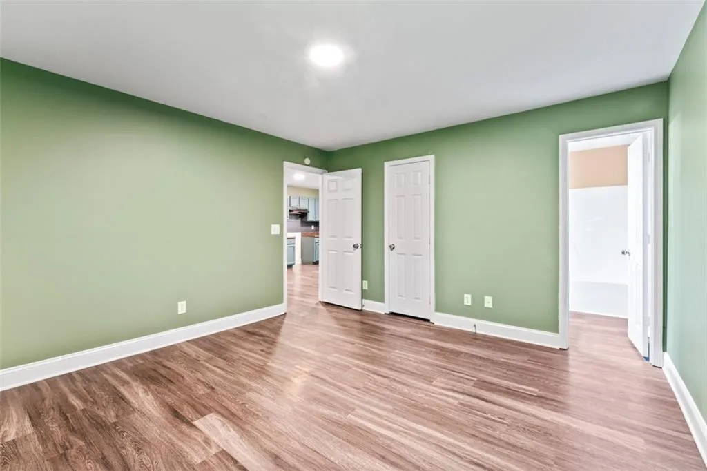 Unfurnished bedroom with wood finished floors