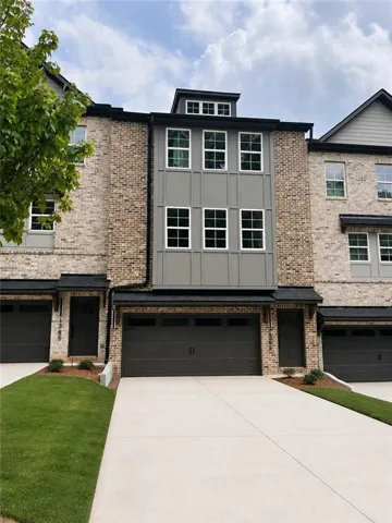 Brick and siding exterior with a dark roofline