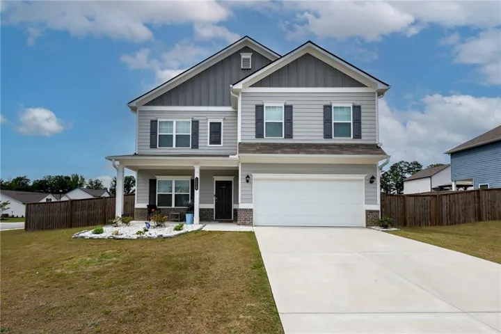 Long, inviting driveway leading to beautiful home with spacious front porch for country living