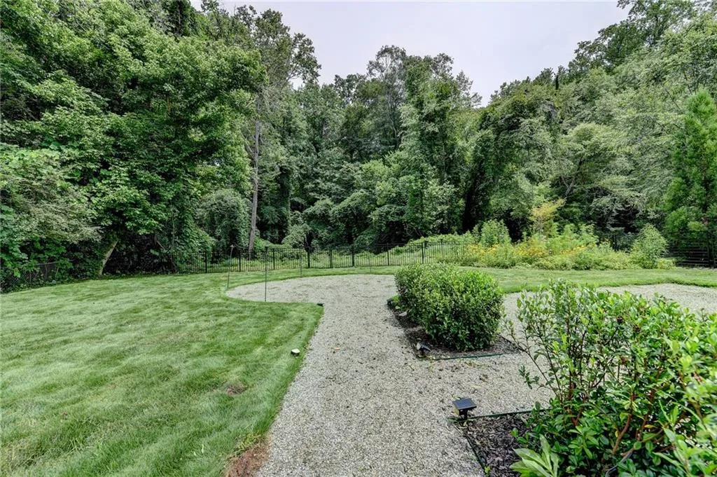 View of yard with a wooded view