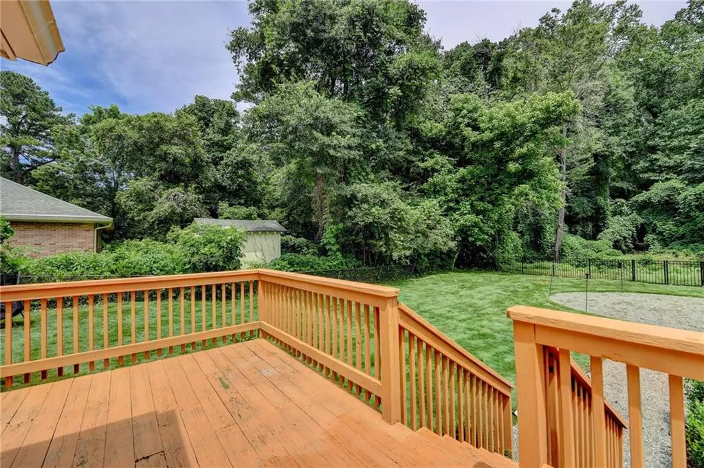 Deck featuring a fenced backyard and an outbuilding