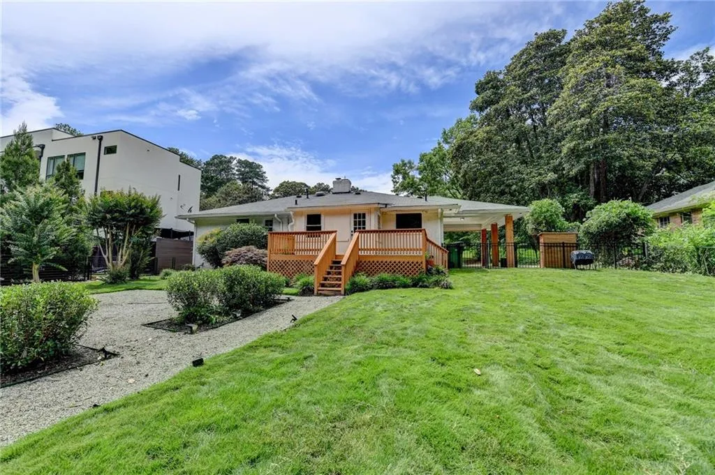 Back of property featuring a wooden deck and stairway