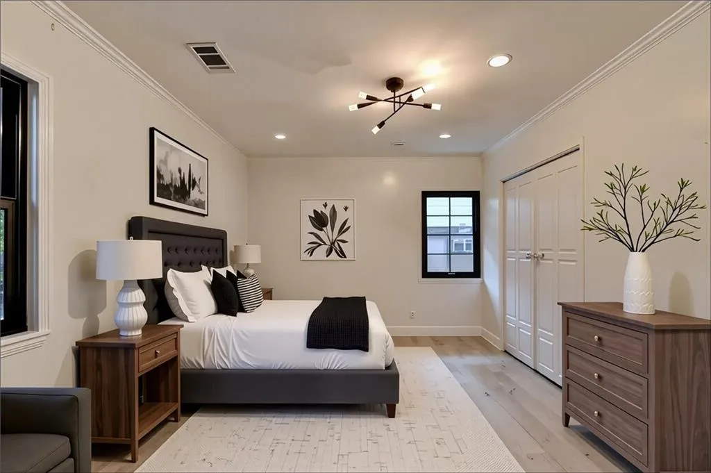 Bedroom featuring light wood-style flooring, crown molding, a chandelier, recessed lighting, and a closet