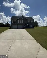 Two-story residence featuring a gray exterior with white trim