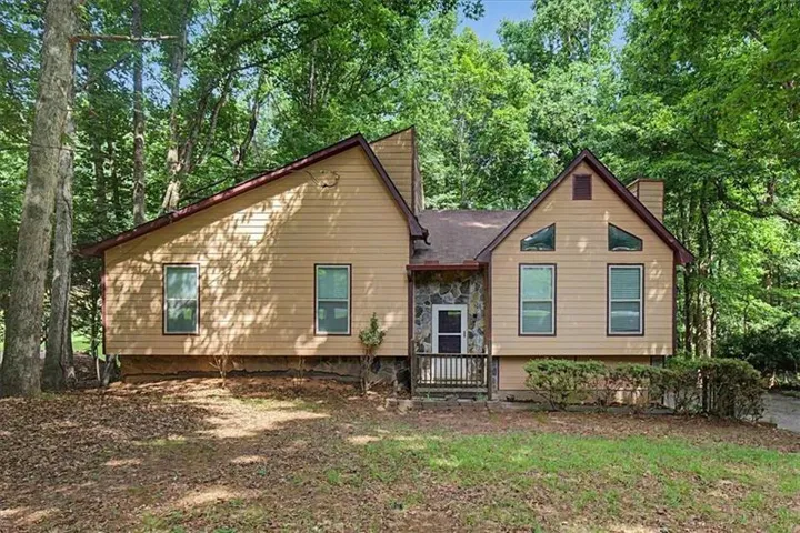 Exterior featuring siding with stone accents, a covered front entry, and a gabled roofline