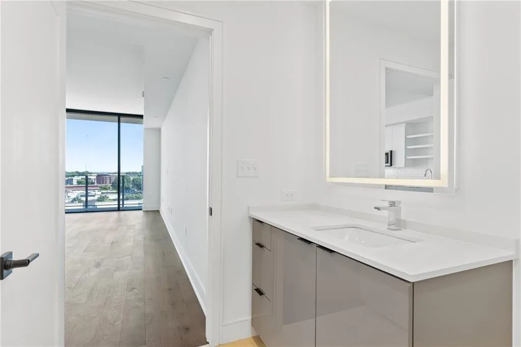 Bathroom with vanity, floor to ceiling windows, and wood finished floors