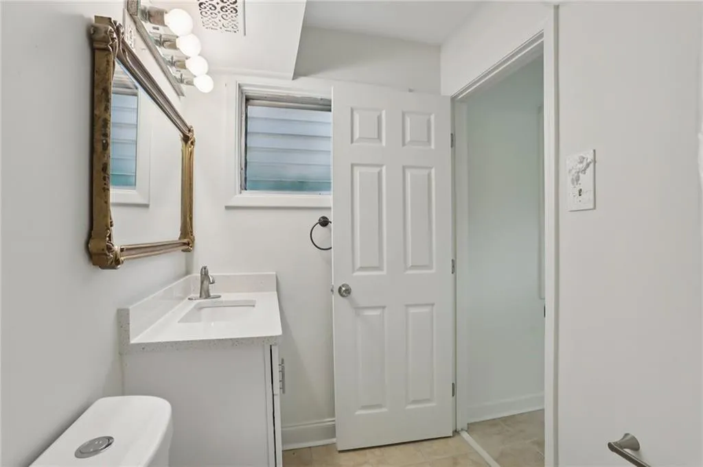 Half bath with vanity and light tile patterned floors