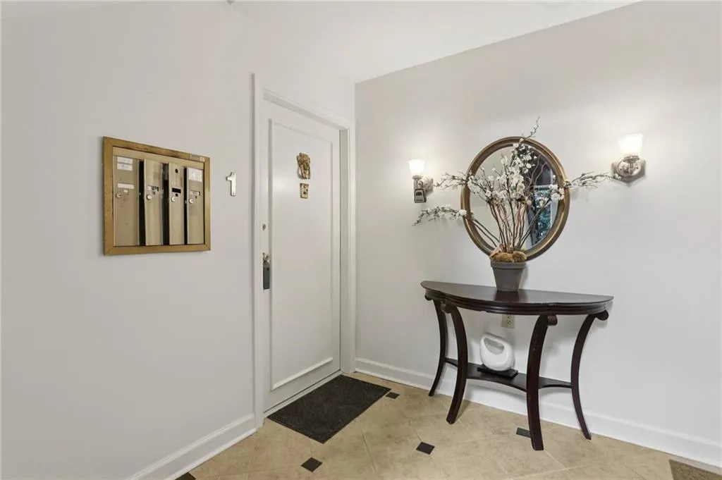 Entrance foyer with baseboards and light tile patterned floors