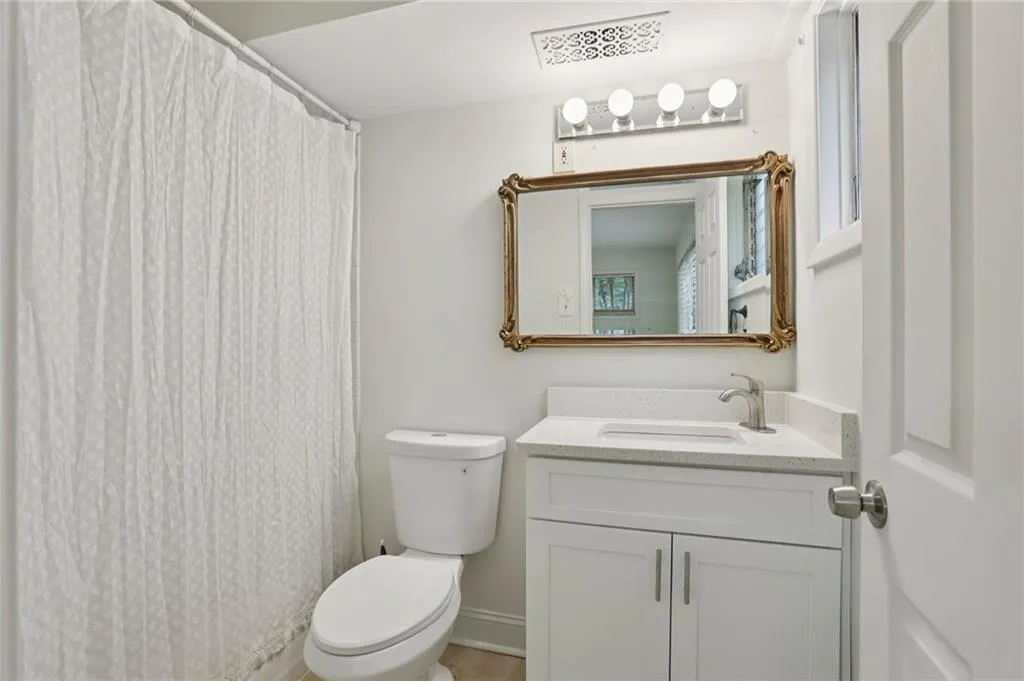 Bathroom with vanity and a shower with shower curtain