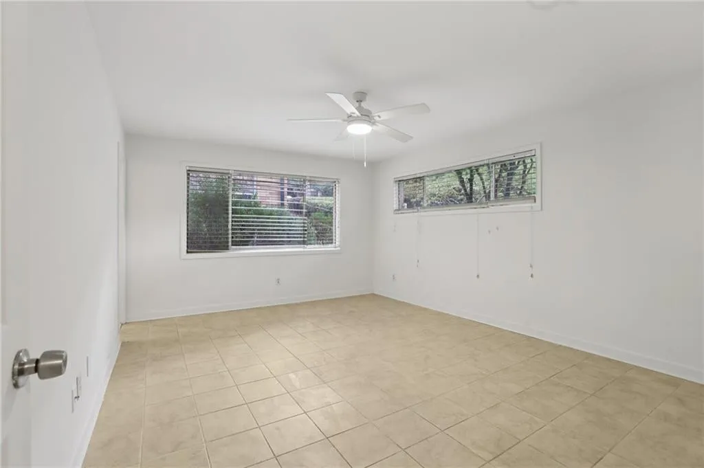 Spare room featuring light tile patterned flooring and ceiling fan