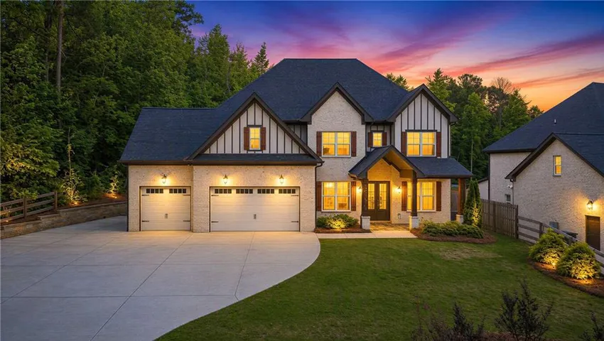 Brick facade residence featuring a multi-gabled roofline and dark accent trim
