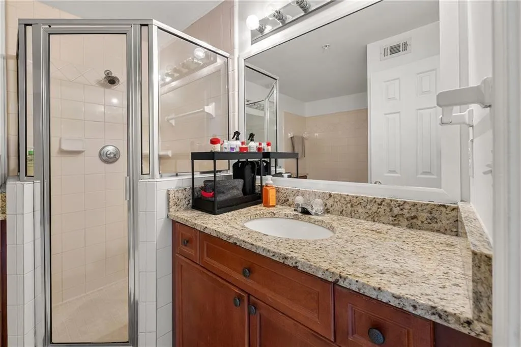 Bathroom with a shower stall and vanity