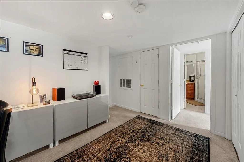 Office space with light colored carpet and baseboards