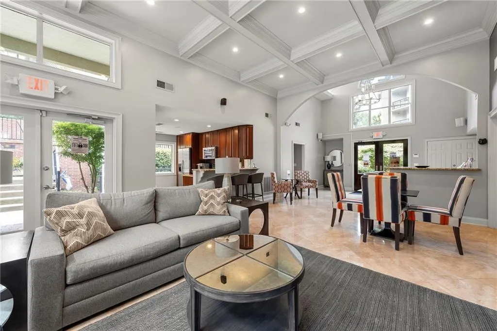 Clubhouse area with french doors, a high ceiling, beam ceiling, coffered ceiling, and recessed lighting