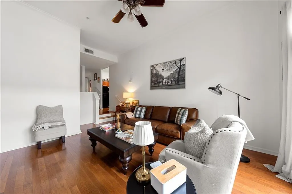 Living room featuring wood finished floors and a ceiling fan