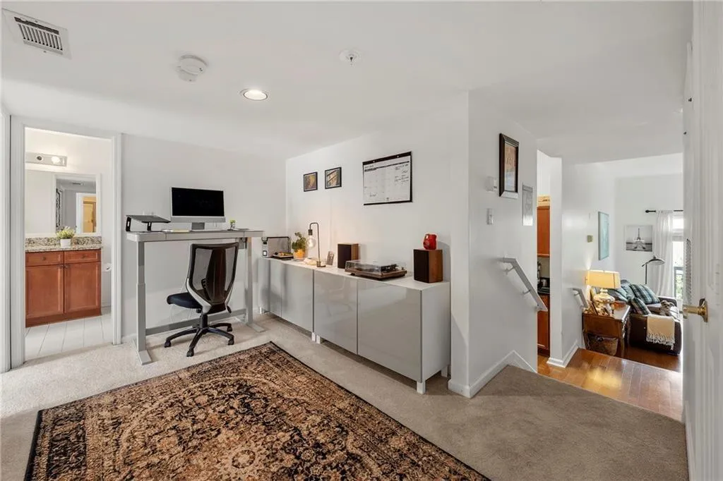 Office area featuring light colored carpet and recessed lighting