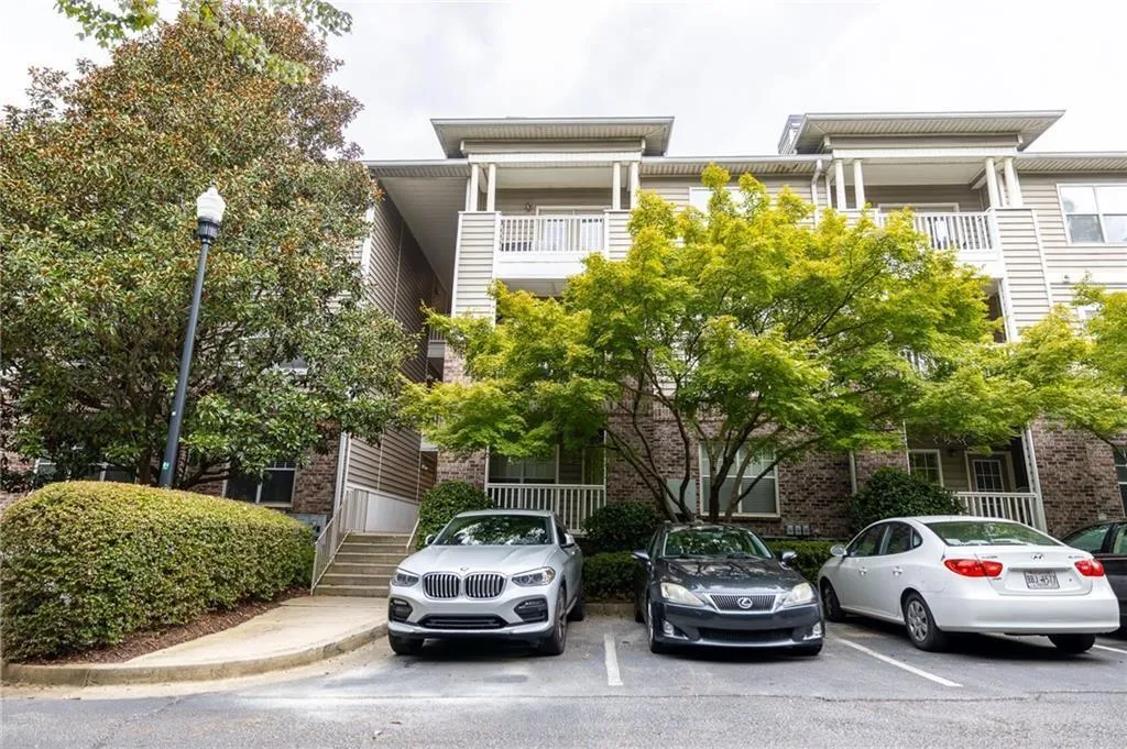View of property with uncovered parking