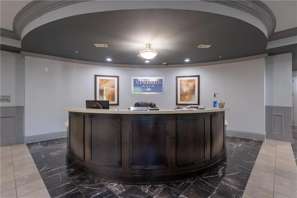 Reception featuring crown molding, wainscoting, a decorative wall, and recessed lighting
