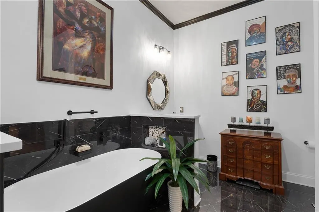 Full bathroom featuring a soaking tub and ornamental molding