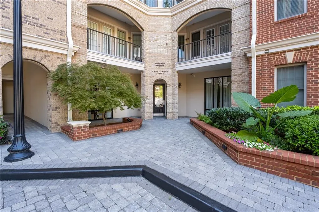 Entrance to property featuring brick siding