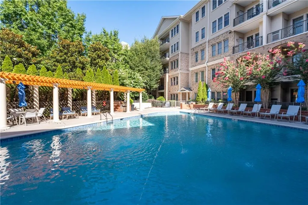 Community pool featuring a patio and a pergola