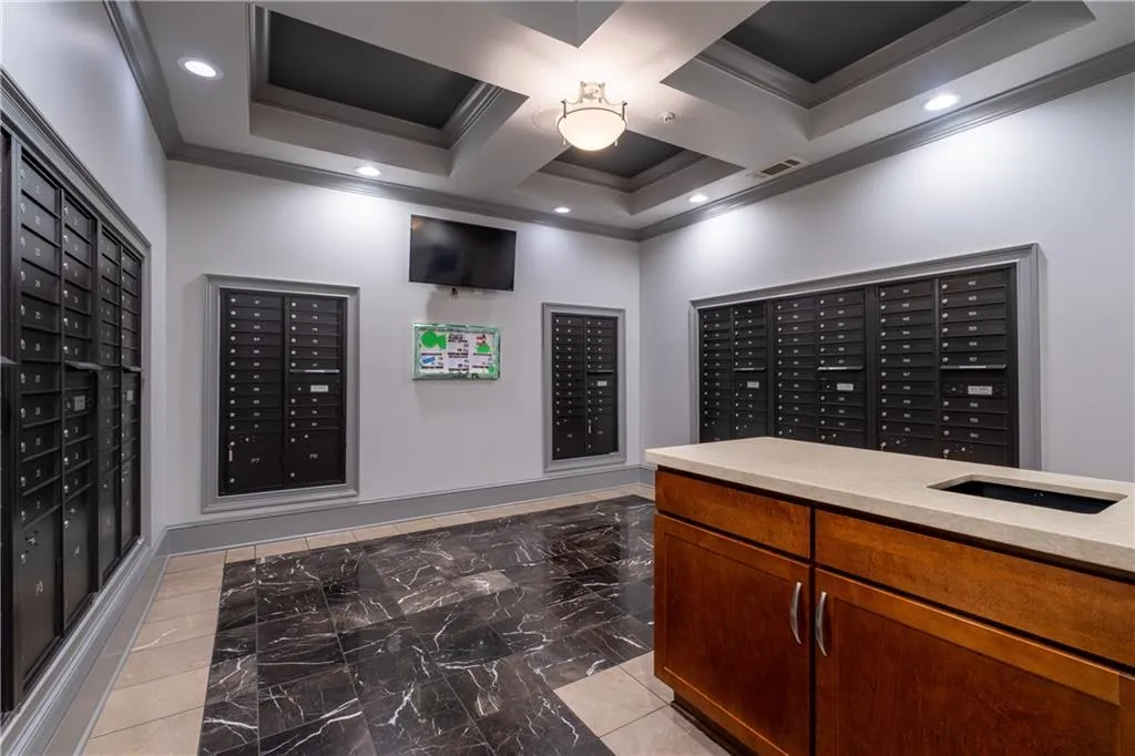 View of property's community featuring crown molding, mail area, recessed lighting, coffered ceiling, and beamed ceiling
